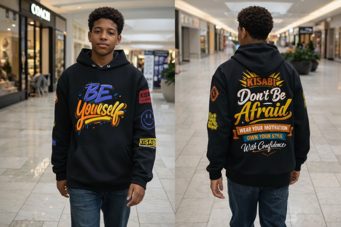 High School student wearing a black hoodie with motivational text in a shopping mall.